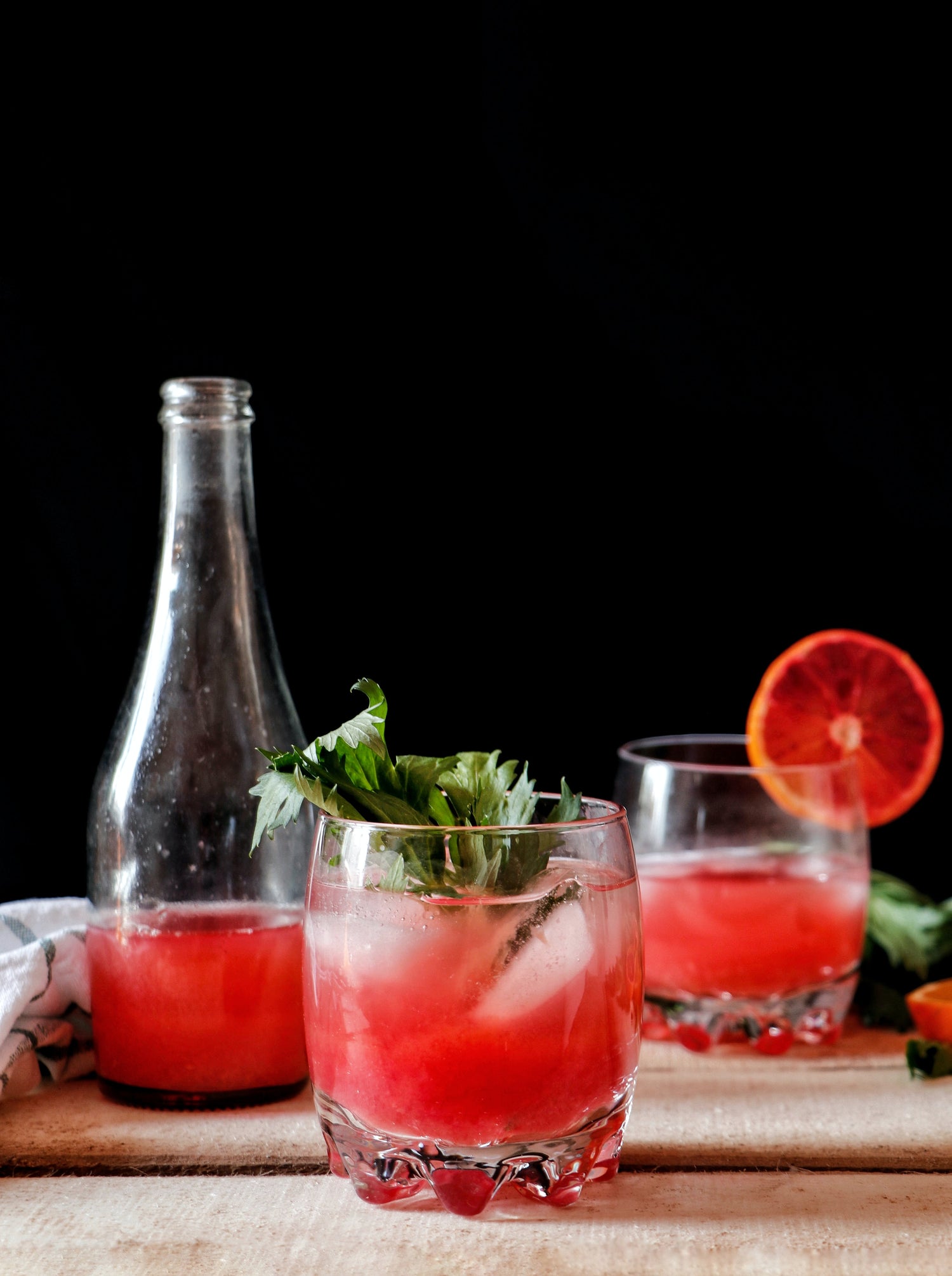 Bright pink juice in glasses on wooden table.